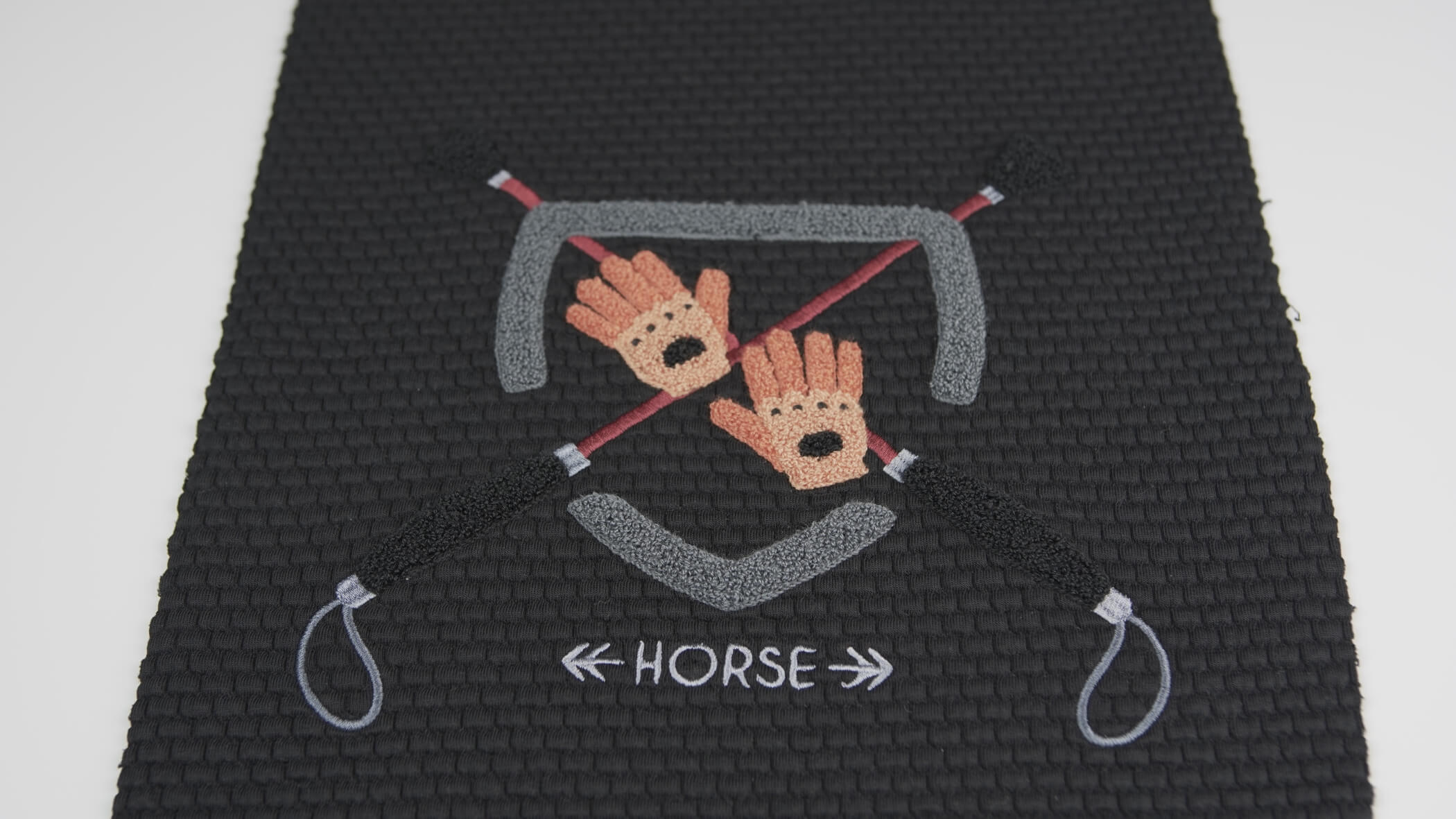 Bordado de Ponto Alto - Chenille onde se vê um brasão com elementos ligados à equitação e a palavra Horse
